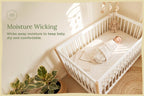 Baby crib sheets in soft white organic cotton on crib mattress