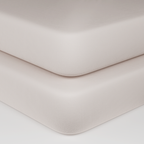 Baby crib sheets in soft white organic cotton on crib mattress